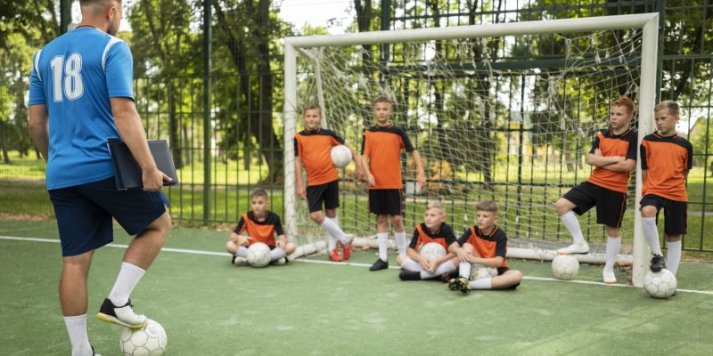 football-trainer-teaching-his-pupils